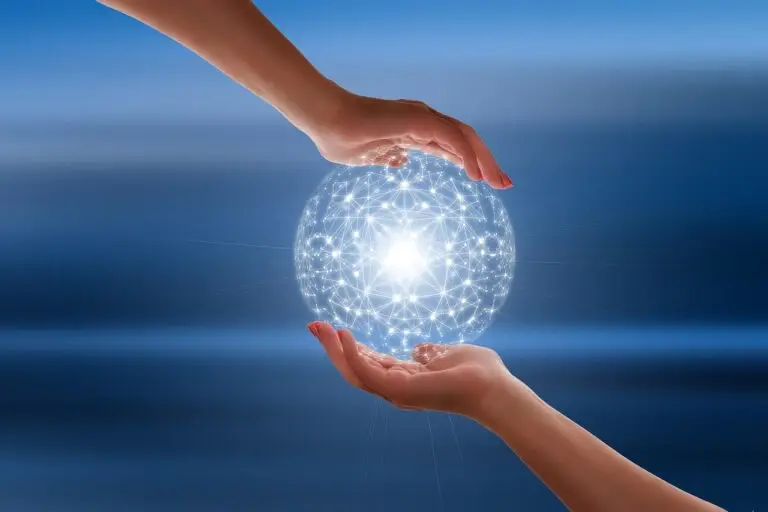 A glowing technological orb held between two hands