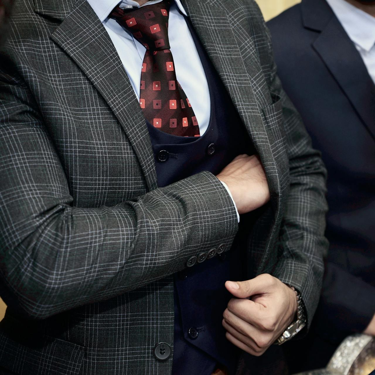 Man reaching into jacket pocket
